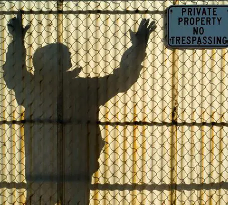 A shadow of a person holding their arms up