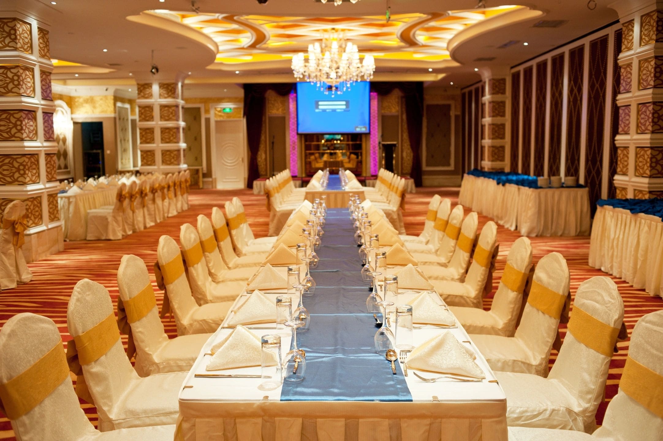 A large banquet hall with long tables and chairs.